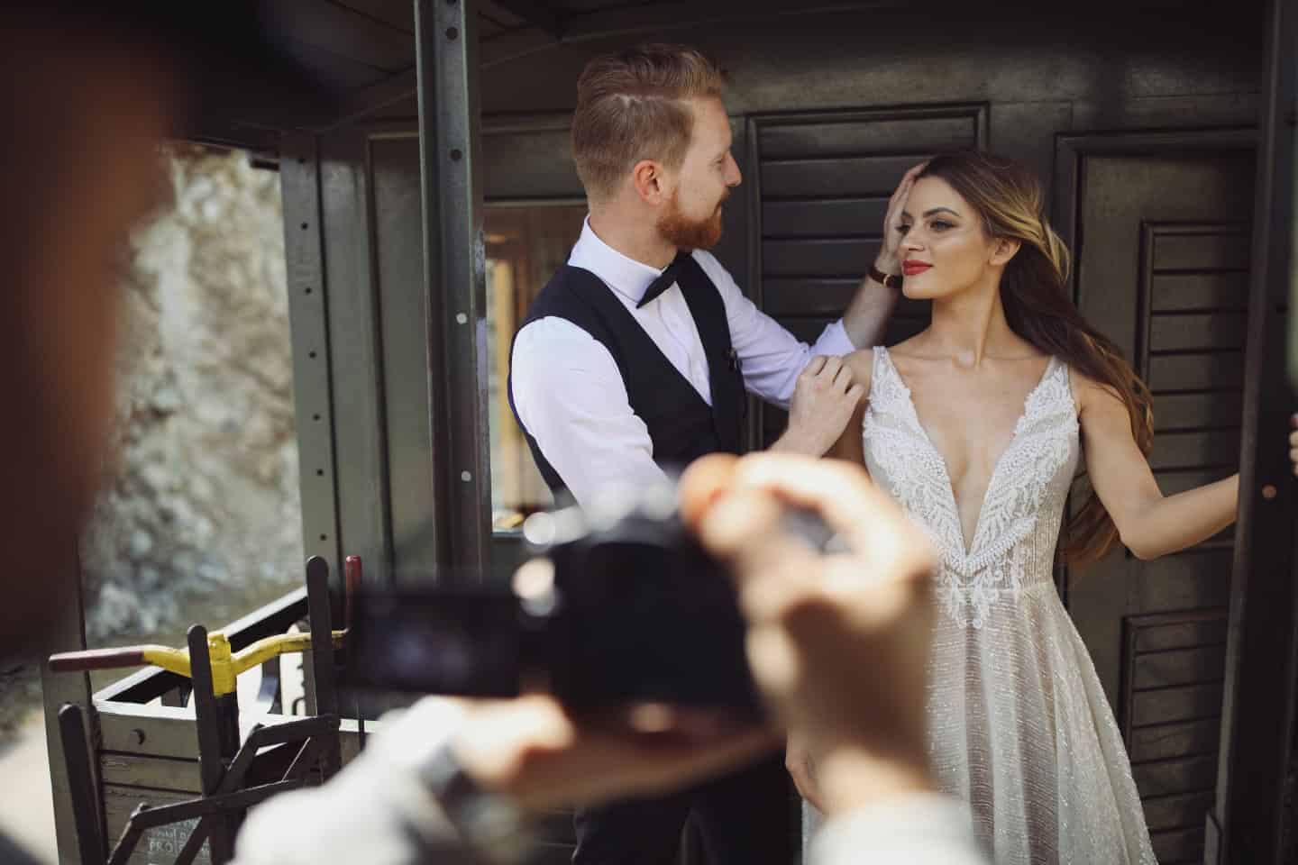 a couple smiling to wedding photographers in Seville