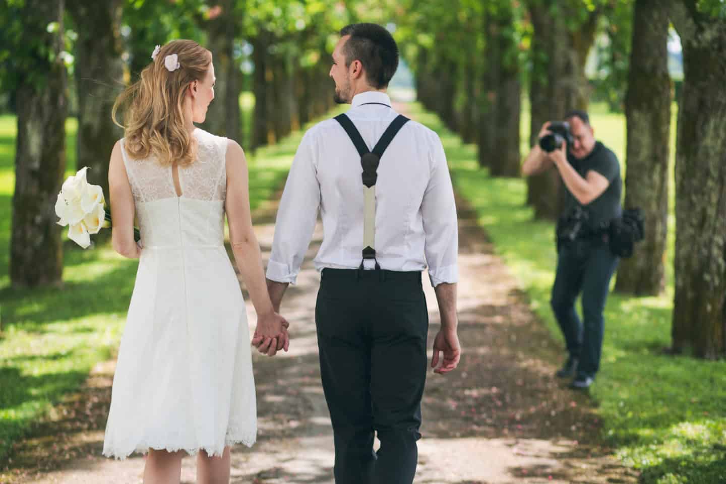 a couple smiling to wedding photographers in Seville